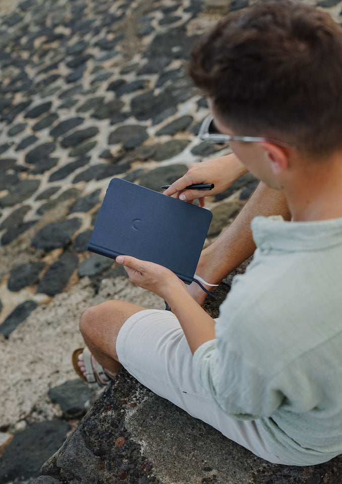 Man with journal on the beach